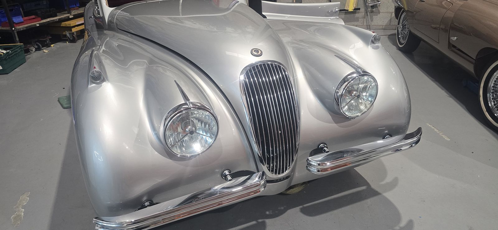 The unmistakable XK120 nose — slatted grille and round headlights in fresh paint
